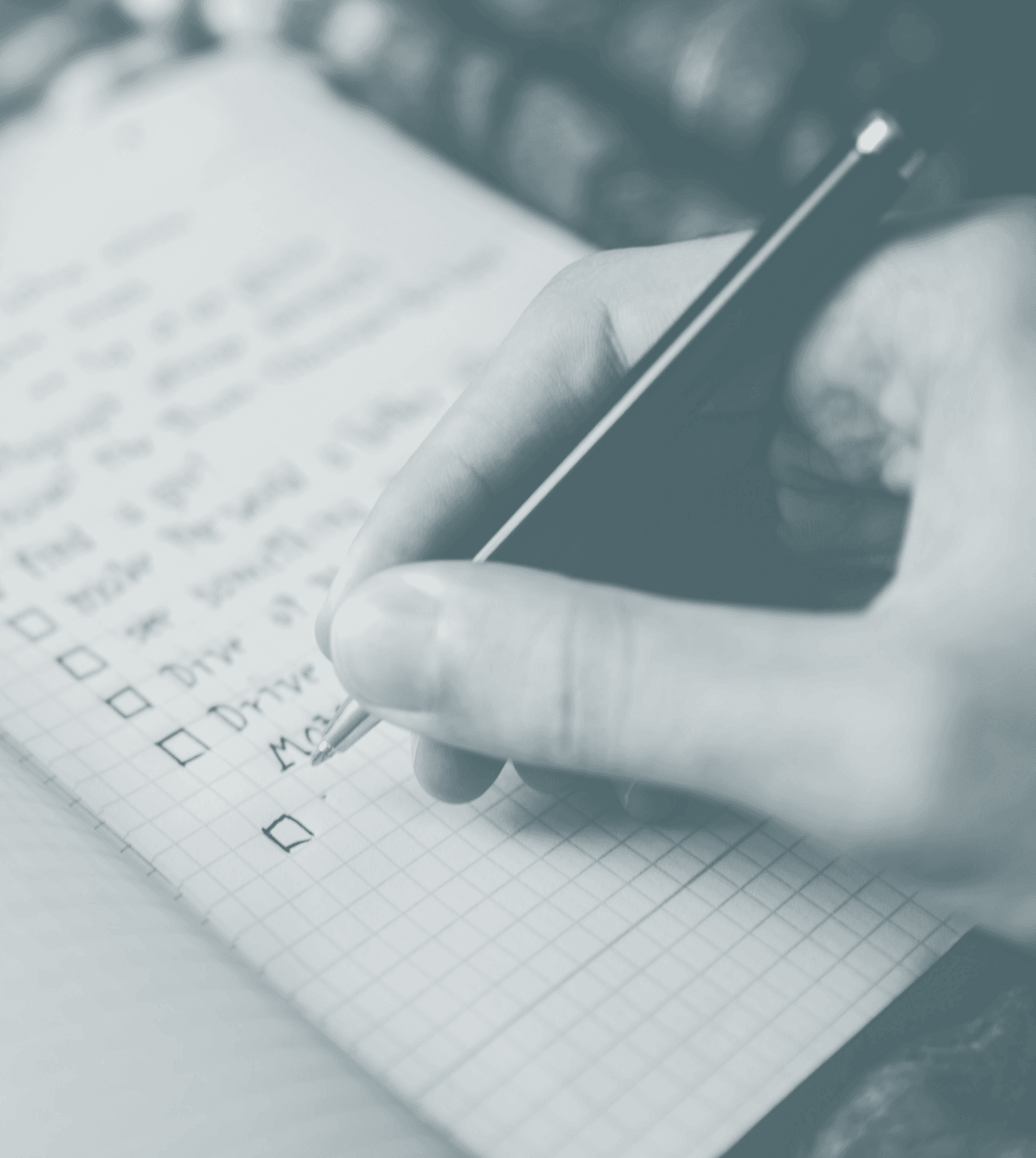Person creating a check list in a notebook